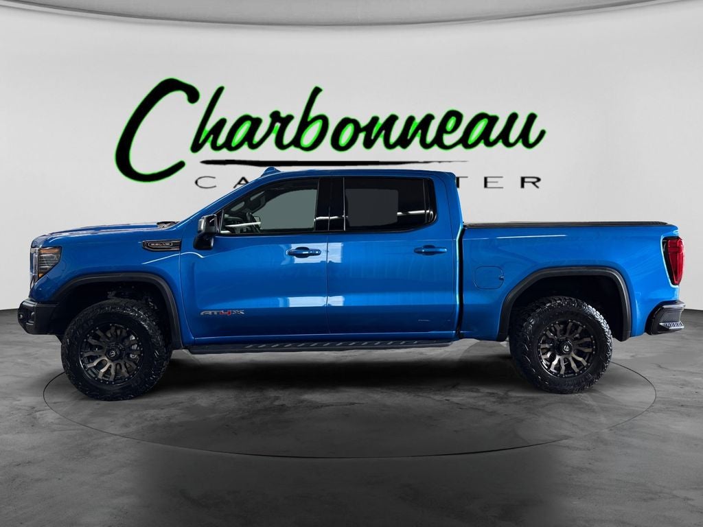 Used 2024 Dynamic Blue Metallic GMC 4WD Crew Cab Short Box AT4X image 2