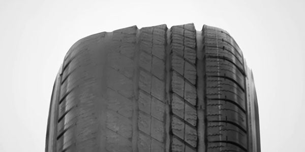 A tire with uneven treadwear damage