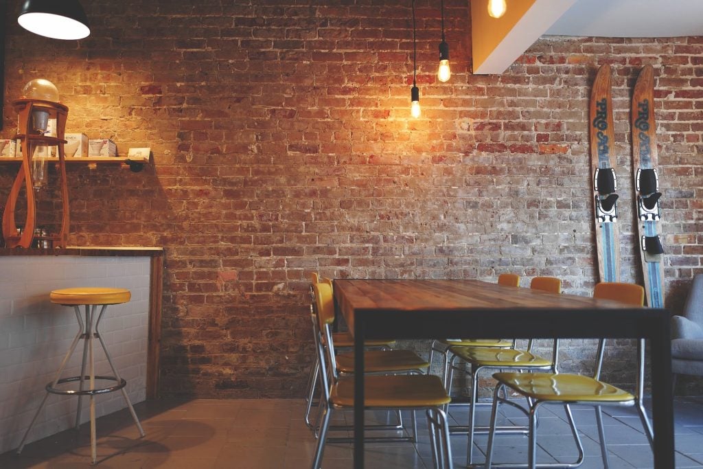 The inside of a restaurant with a brick wall.
