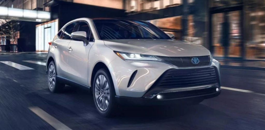 A white 2022 Toyota Venza driving down the road.