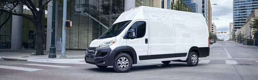 White RAM ProMaster cargo van parked on city street