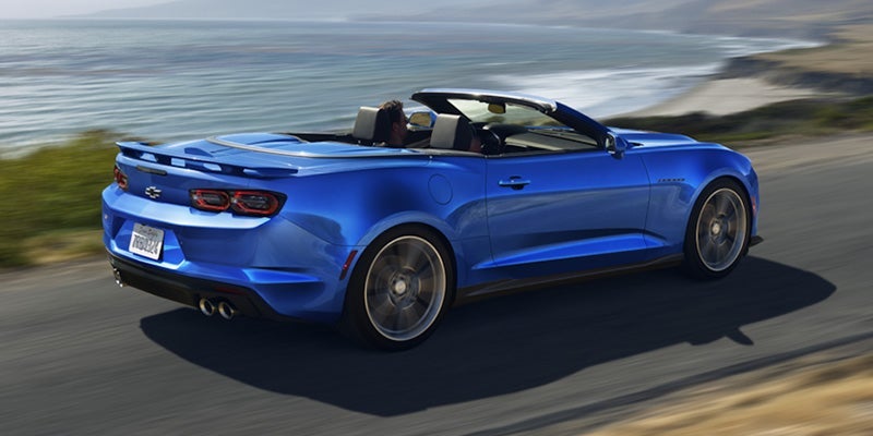 A blue, 2024 Chevy Camaro with the top down.