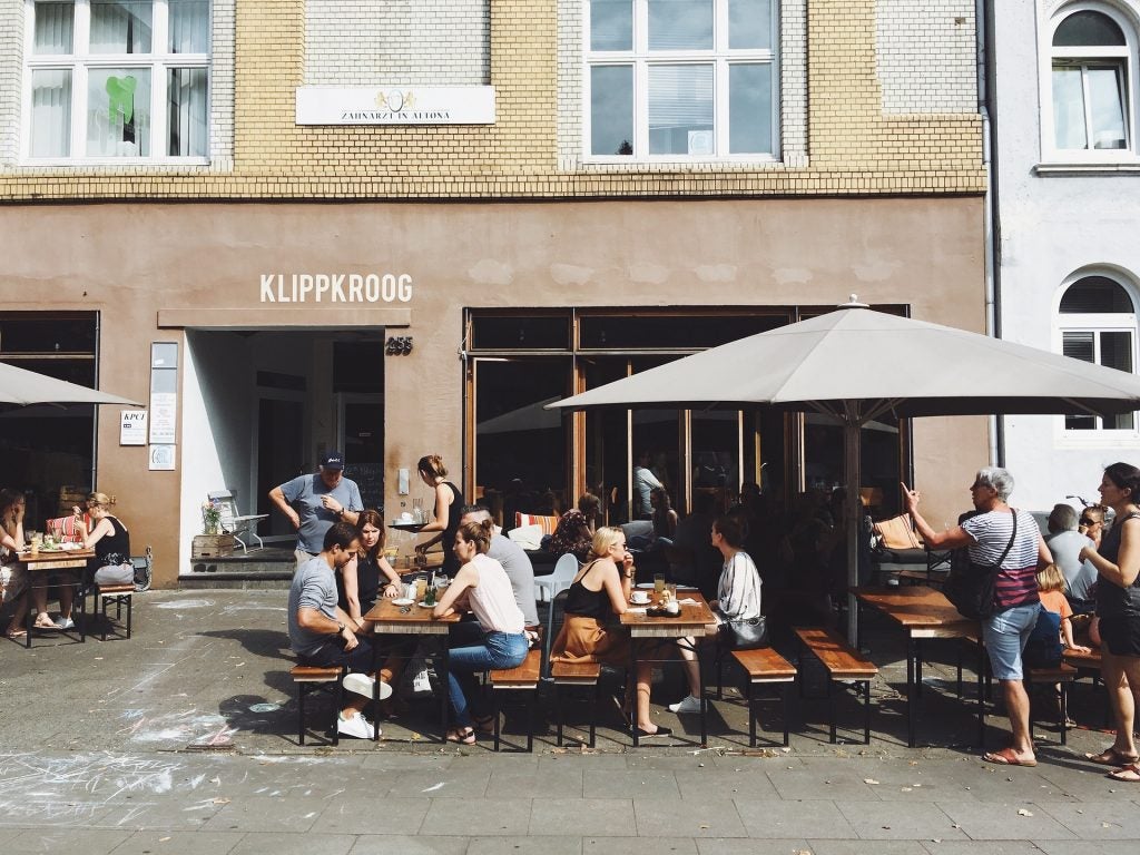 People in front of a restaurant.