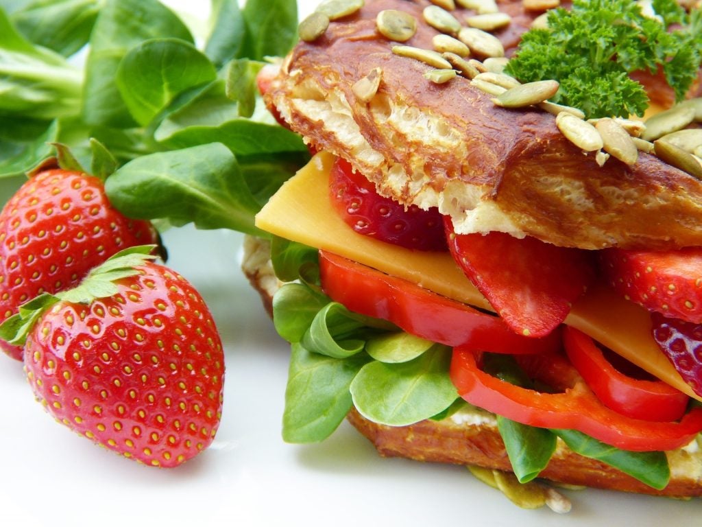 A sandwich with a strawberry.