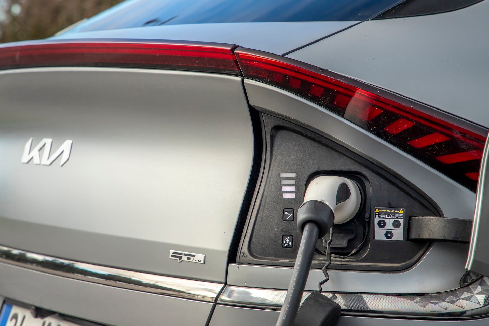 Kia EV6 is a battery electric compact crossover SUV, is charging in the charging station.