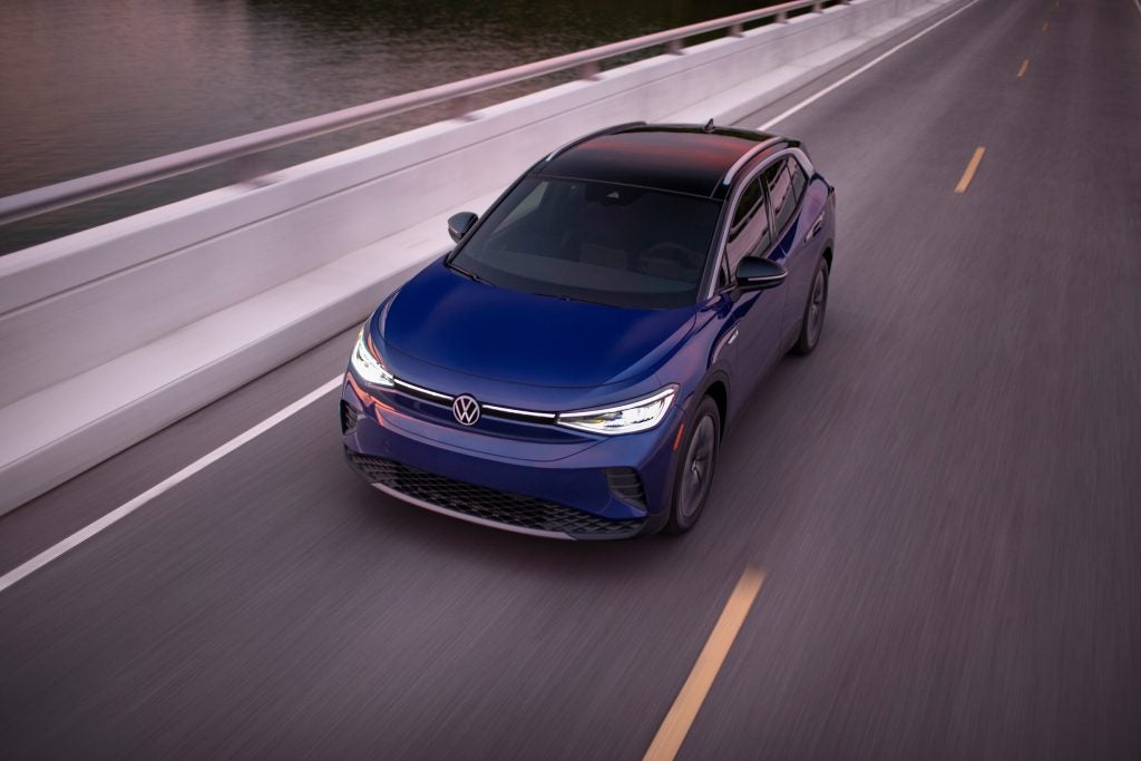 birds eye view of a blue volkswagen ID4 driving on a highway