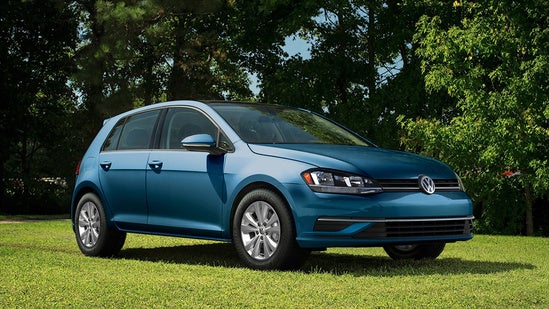 blue volkswagen parked on a field