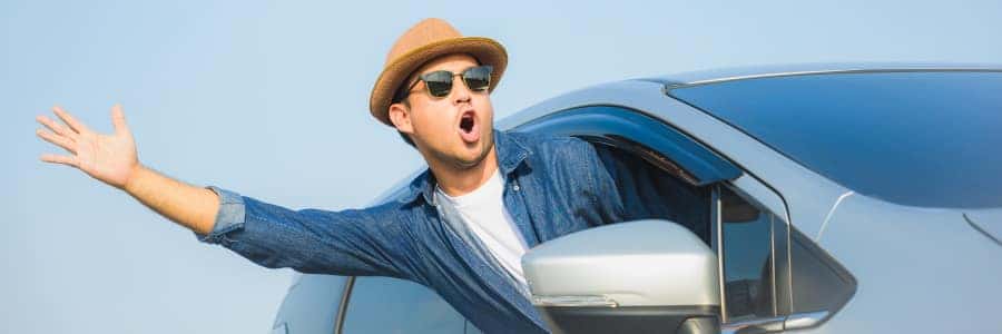 excited man driving a vehicle