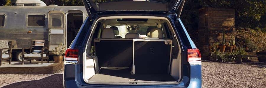 rear view of a blue 2022 VW atlas with the trunk open and back seats folded down