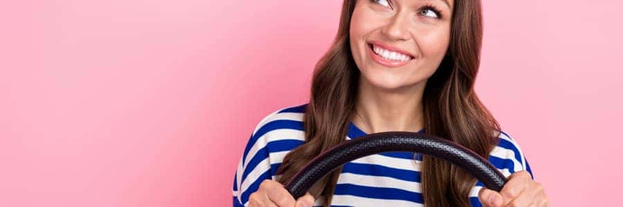 college grad holding a steering wheel