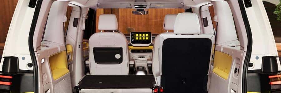 interior view of the VW ID Buzz van, with yellow interior accents and the backseats folded down