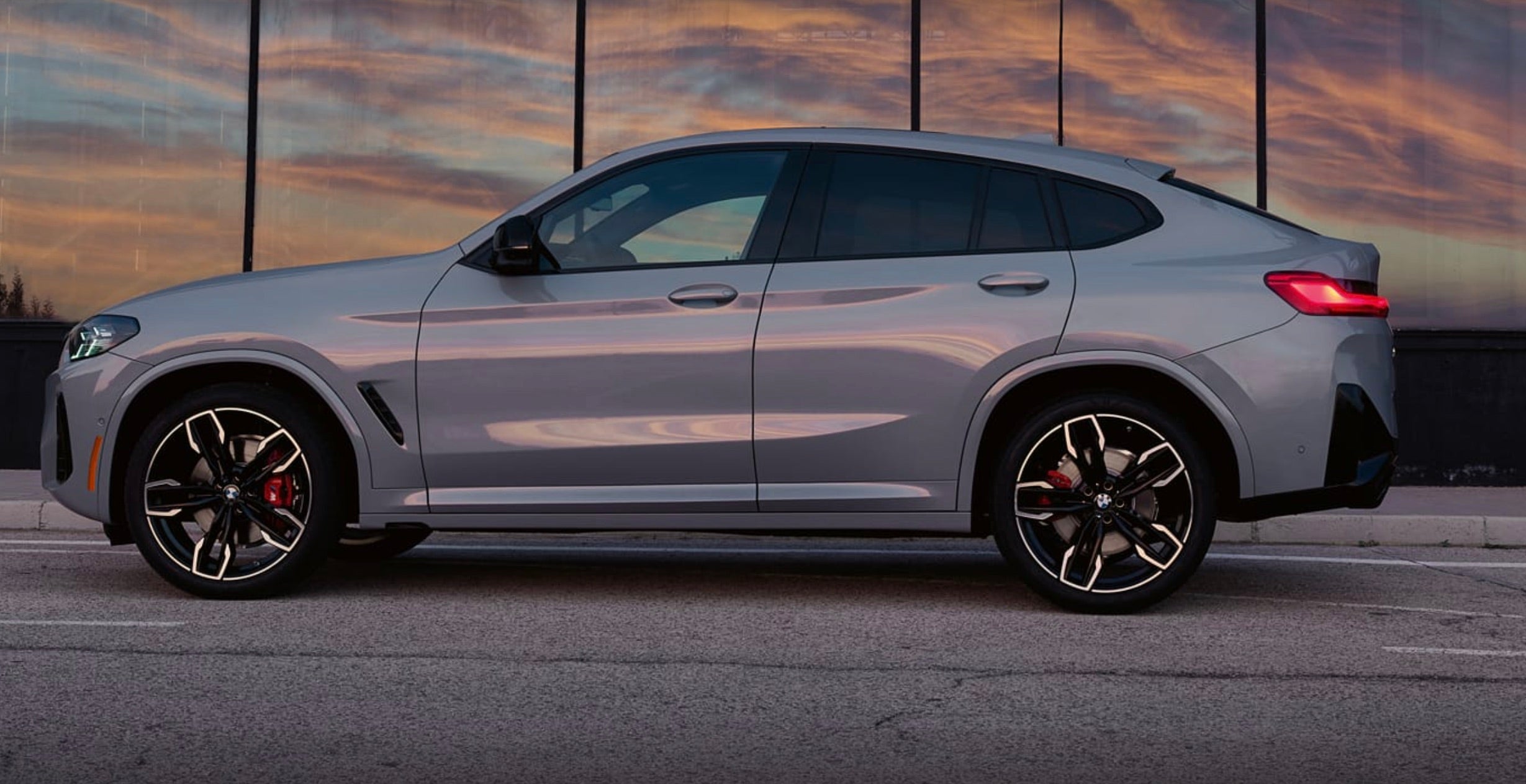 BMW X4 M30i parked with the sun setting out of frame.