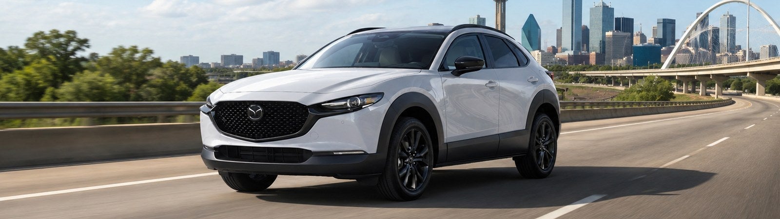 Used Mazda SUV driving toward Dallas during a summer road trip from Waco