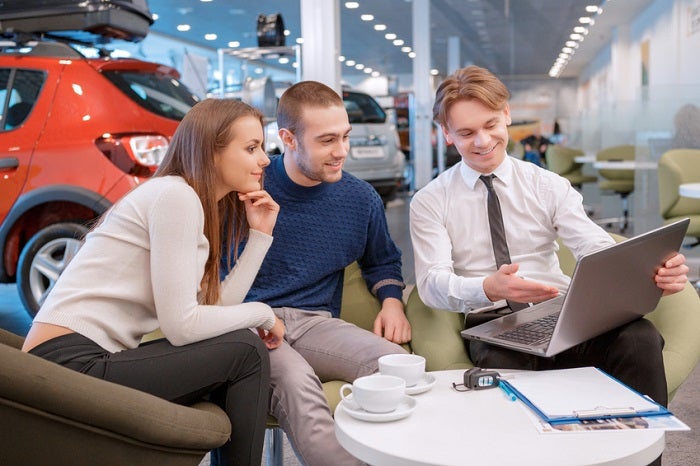 Couple communicating with the salesman in showroom