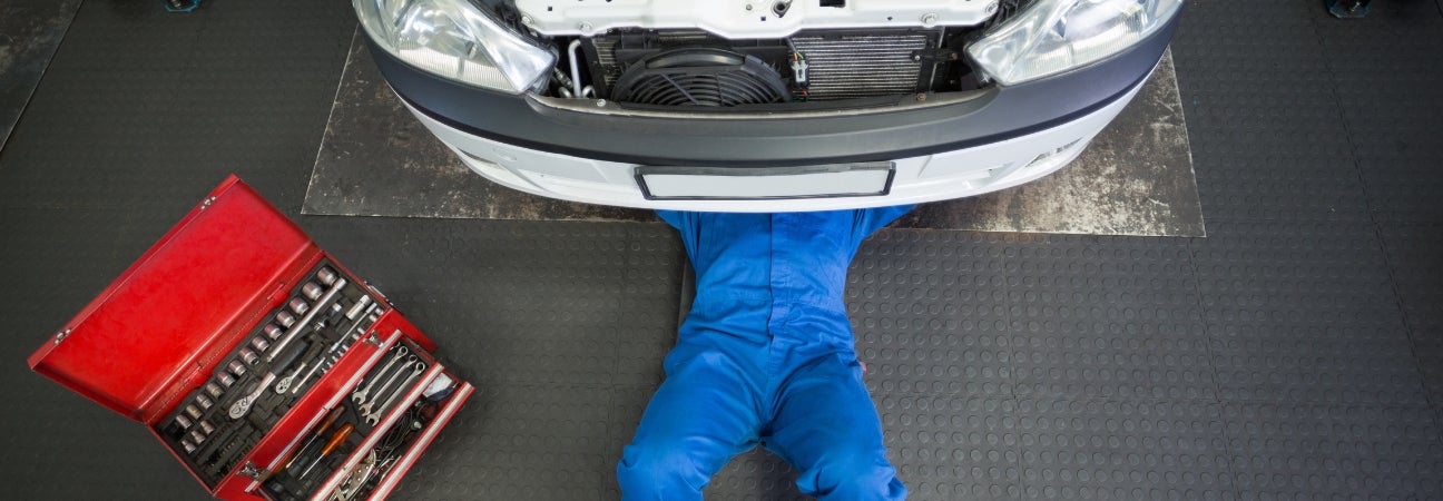 Technician working under car