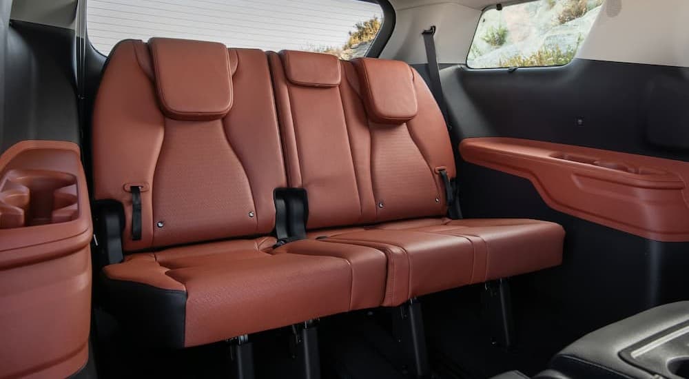 Black and brown rear interior in a 2026 Kia Carnival.