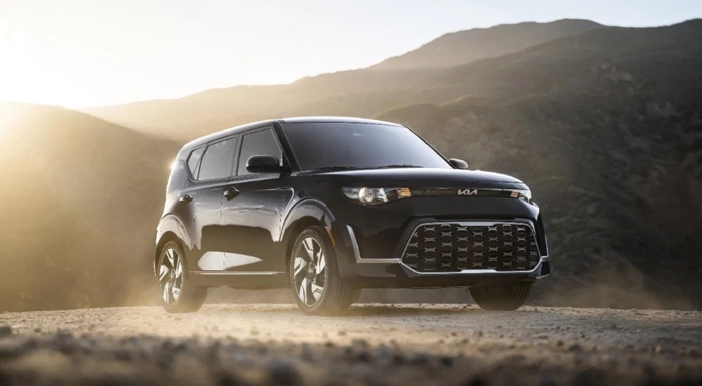 A black 2023 Kia Soul parked offroad.