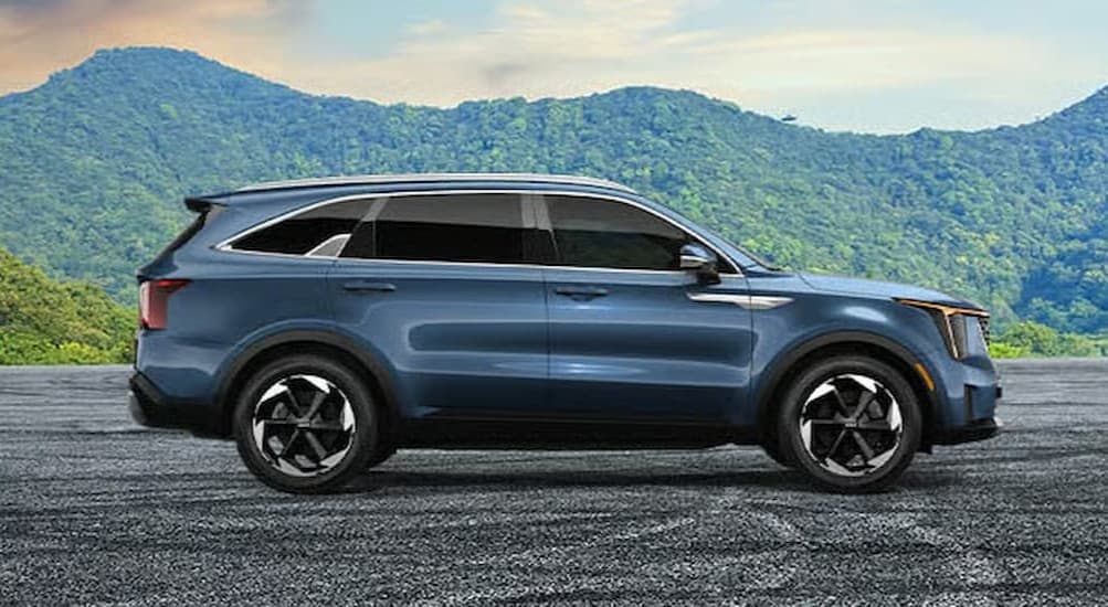A blue 2026 Kia Sorento parked off-road.