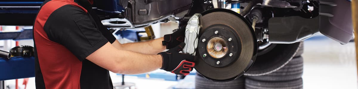 A Toyota Service Technician replacing the brakes on a vehicle