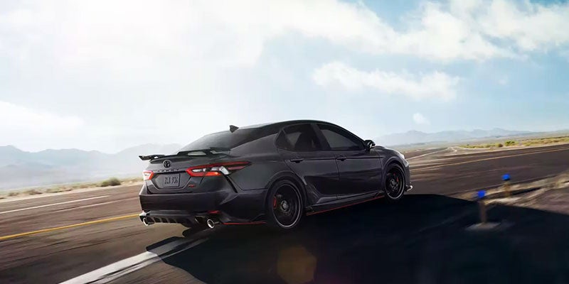 A certified pre-owned 2023 Toyota Camry taking a highway turn near St. Louis, MO 