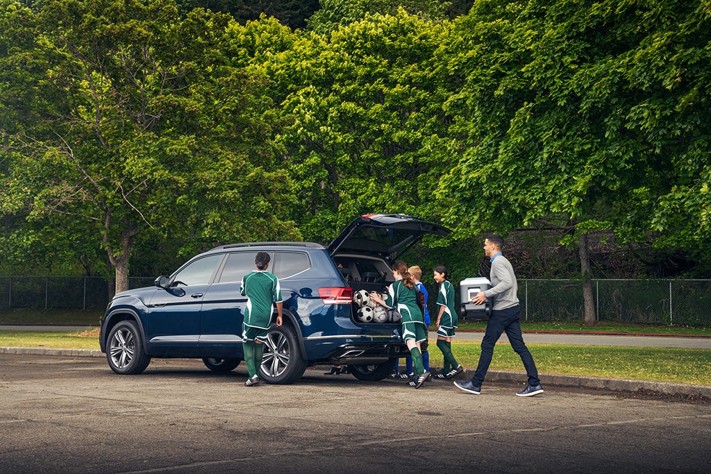 VW Atlas with trunk open, family loading soccer gear