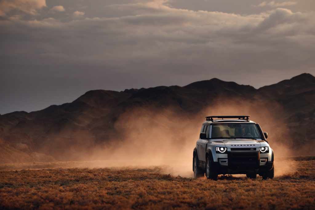 New Land Rover Defender driving through desert