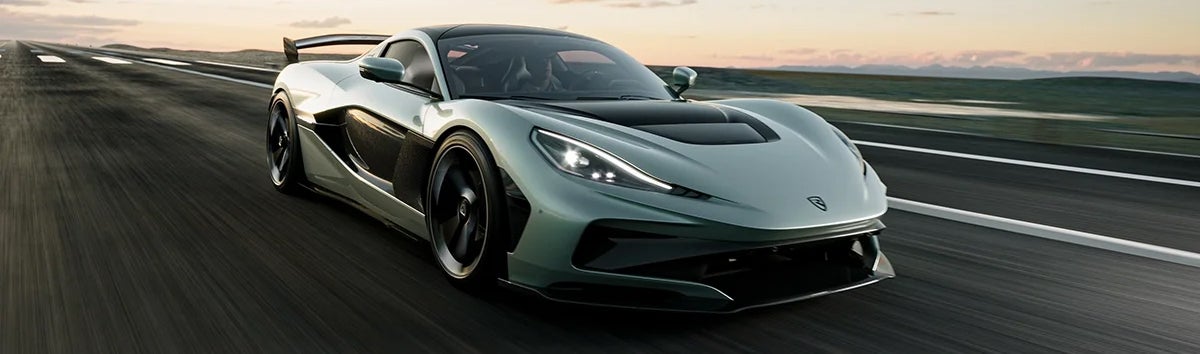 Mint-green Rimac Nevera R on an open road.