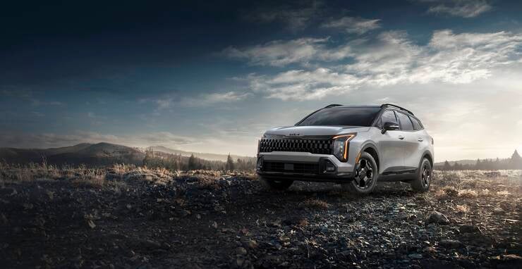 2026 Kia Sportage shown from the front three-quarter angle in an outdoor setting