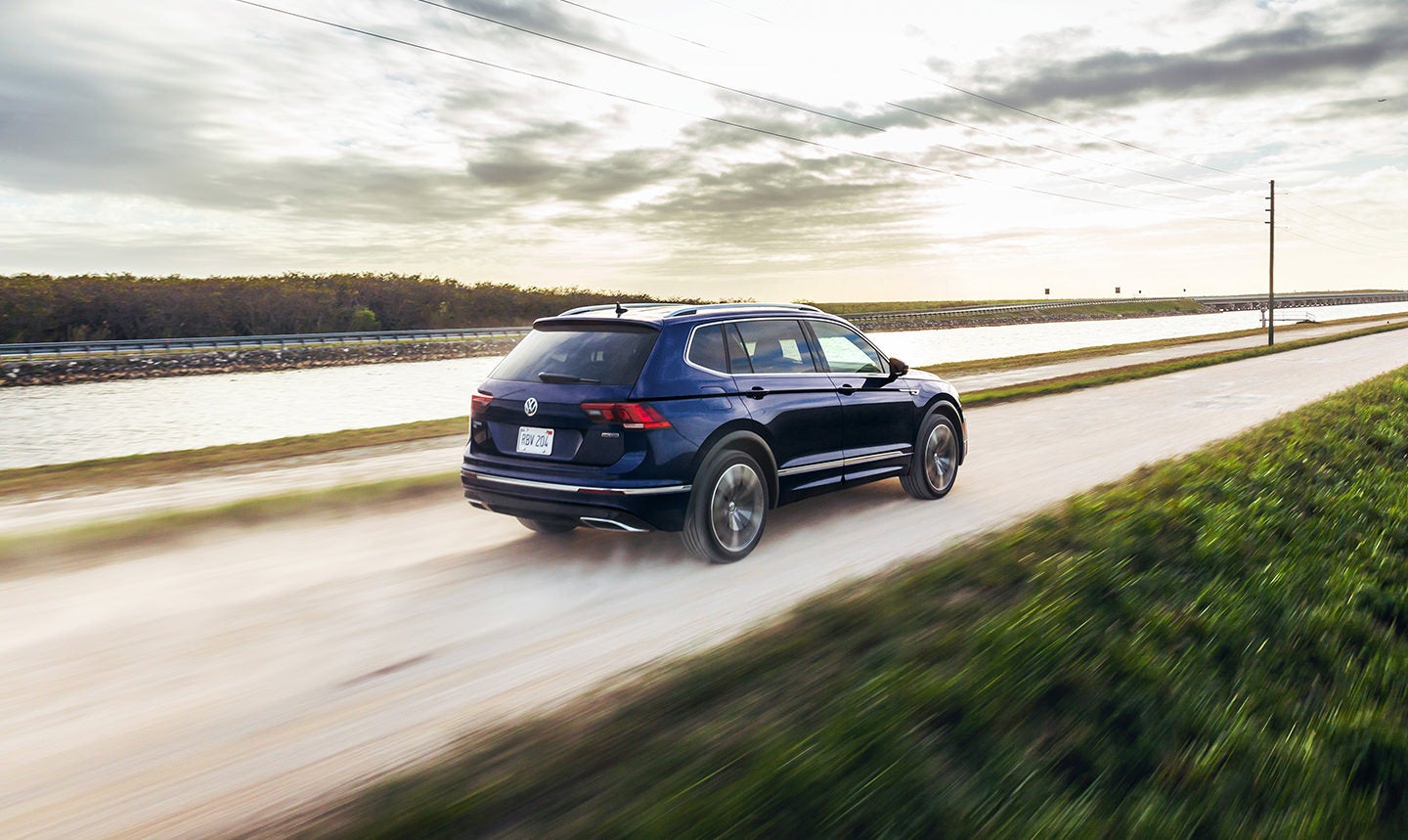 The 2021 VW Tiguan driving down a dirt road.