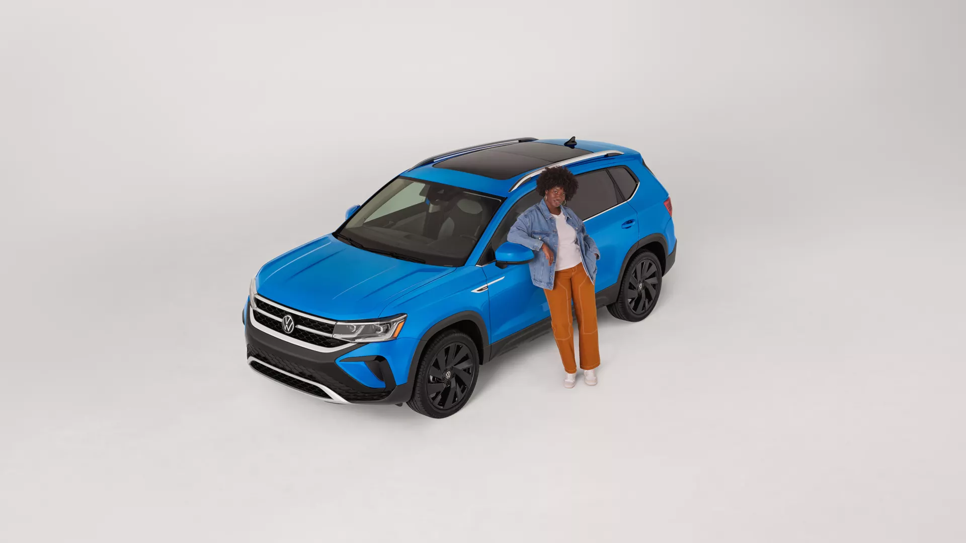 Woman standing beside a VW Toas