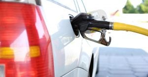 Pumping gas into a car at a gas station | Gunther Kia