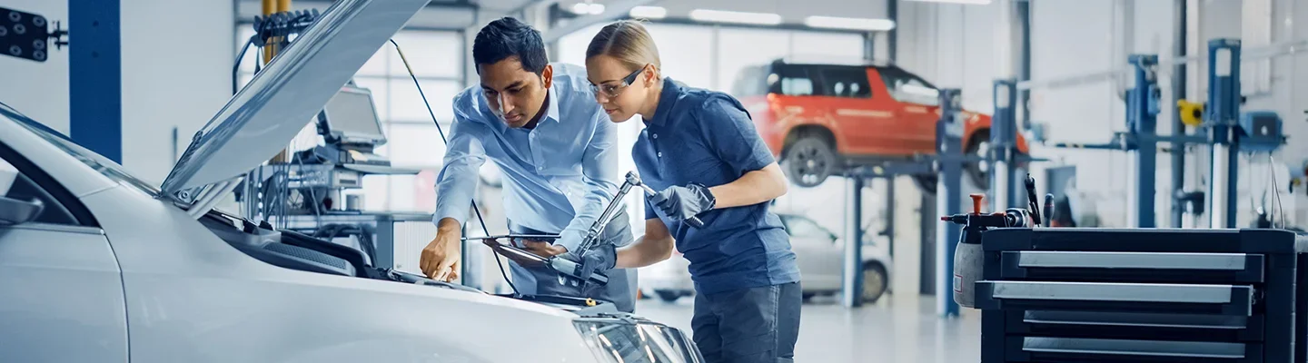 techs working on engine of car