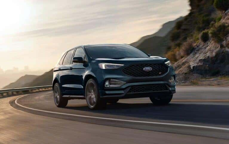 Blue Ford Edge driving on the road