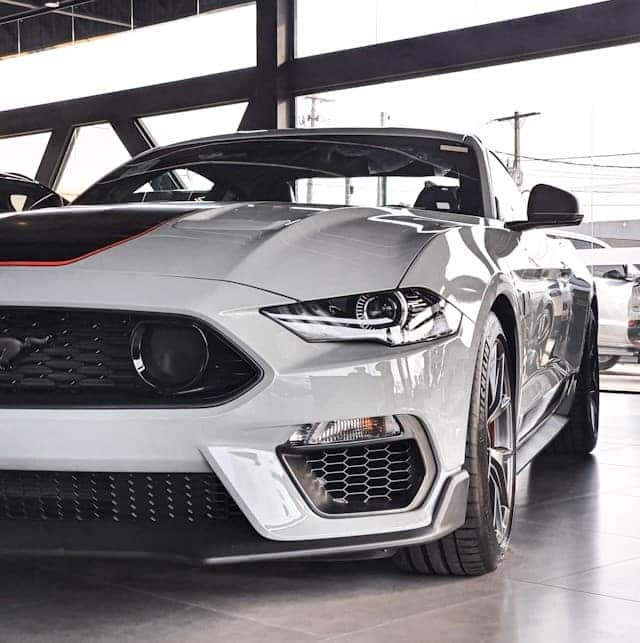 a white sports car parked in a garage