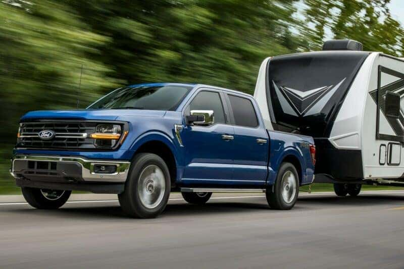 Blue Ford F-150 towing a trialer