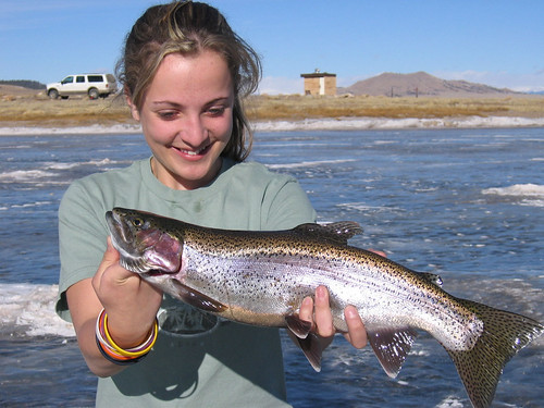 Hannah fishing and catching a trout