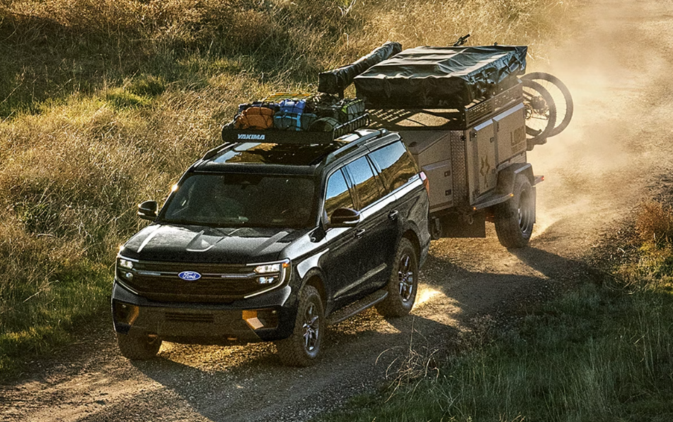 Black 2027 Ford Expedition towing a trailer