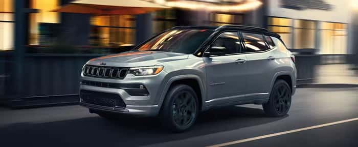 Gray Jeep Compass driving on the road