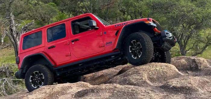 Jeep Wrangler driving over rocks