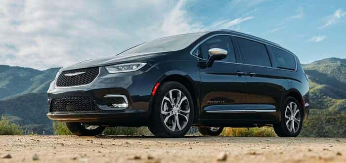 Black Chrysler Pacifica parked in the dirt
