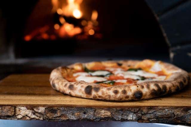 Pizza on brown wooden table