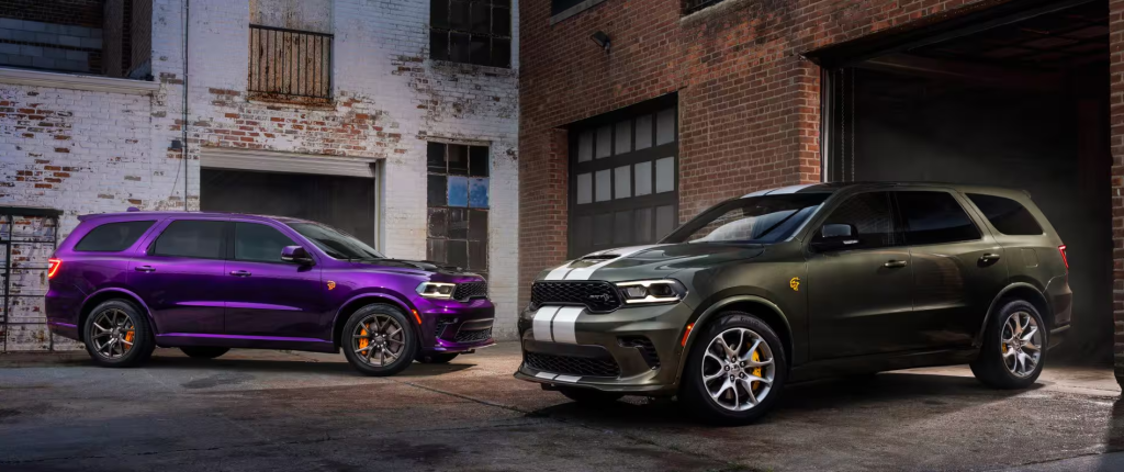 Two 2026 Dodge Durangos parked outside garage