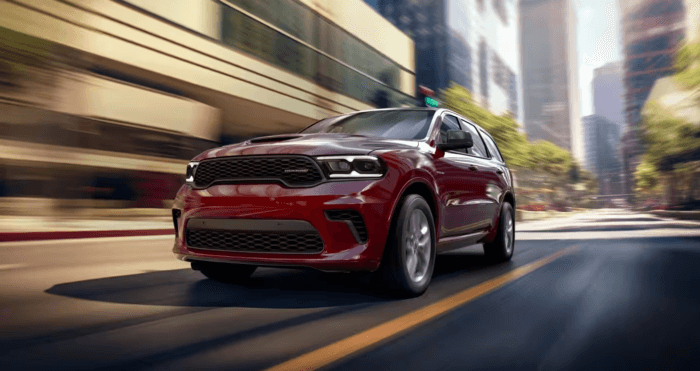 Red 2025 Dodge Durango driving on road