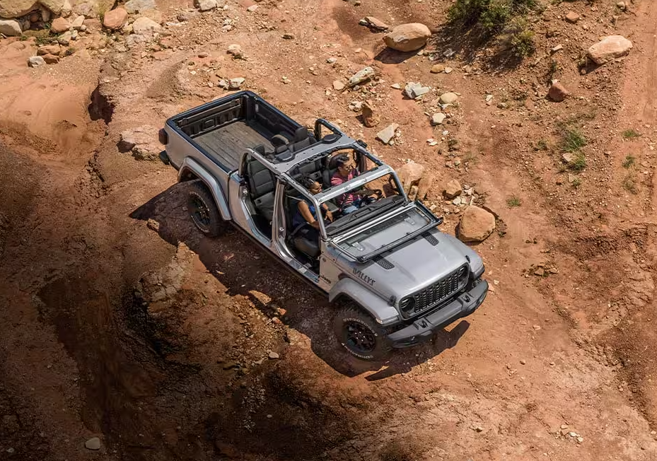 Gray 2026 Jeep Gladiator Willy's driving off-road