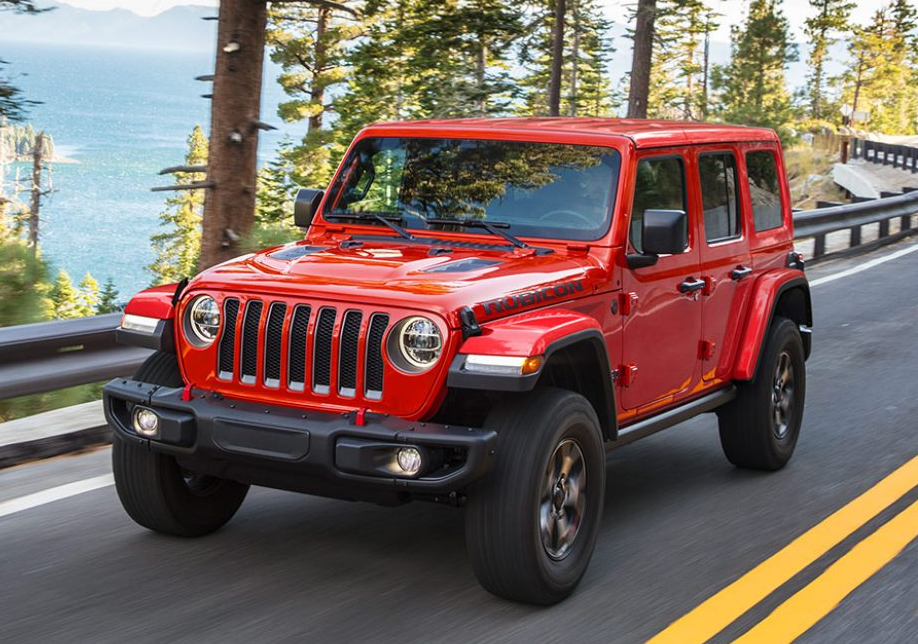 Red Used Jeep Wrangler driving on road