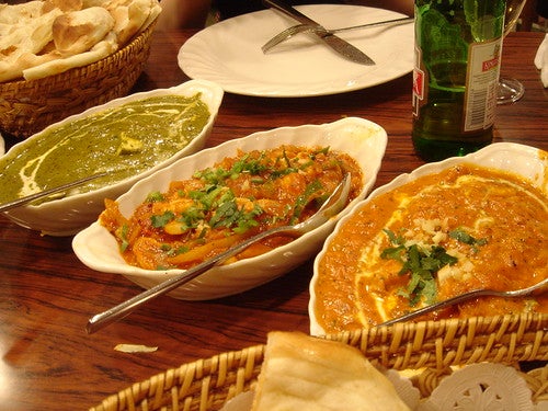 Indian food dishes on table.