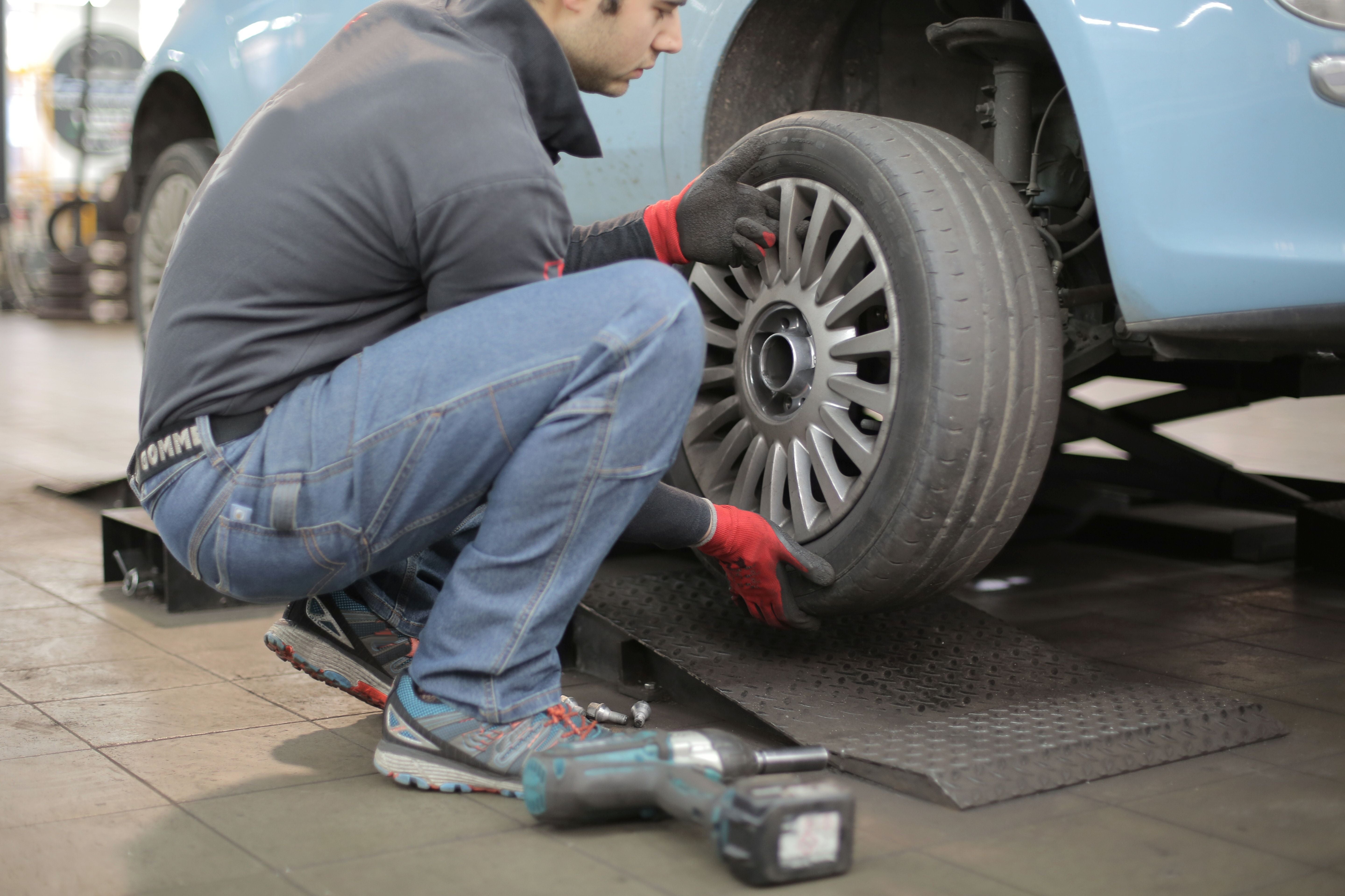 Tire Technician replacing a wheel