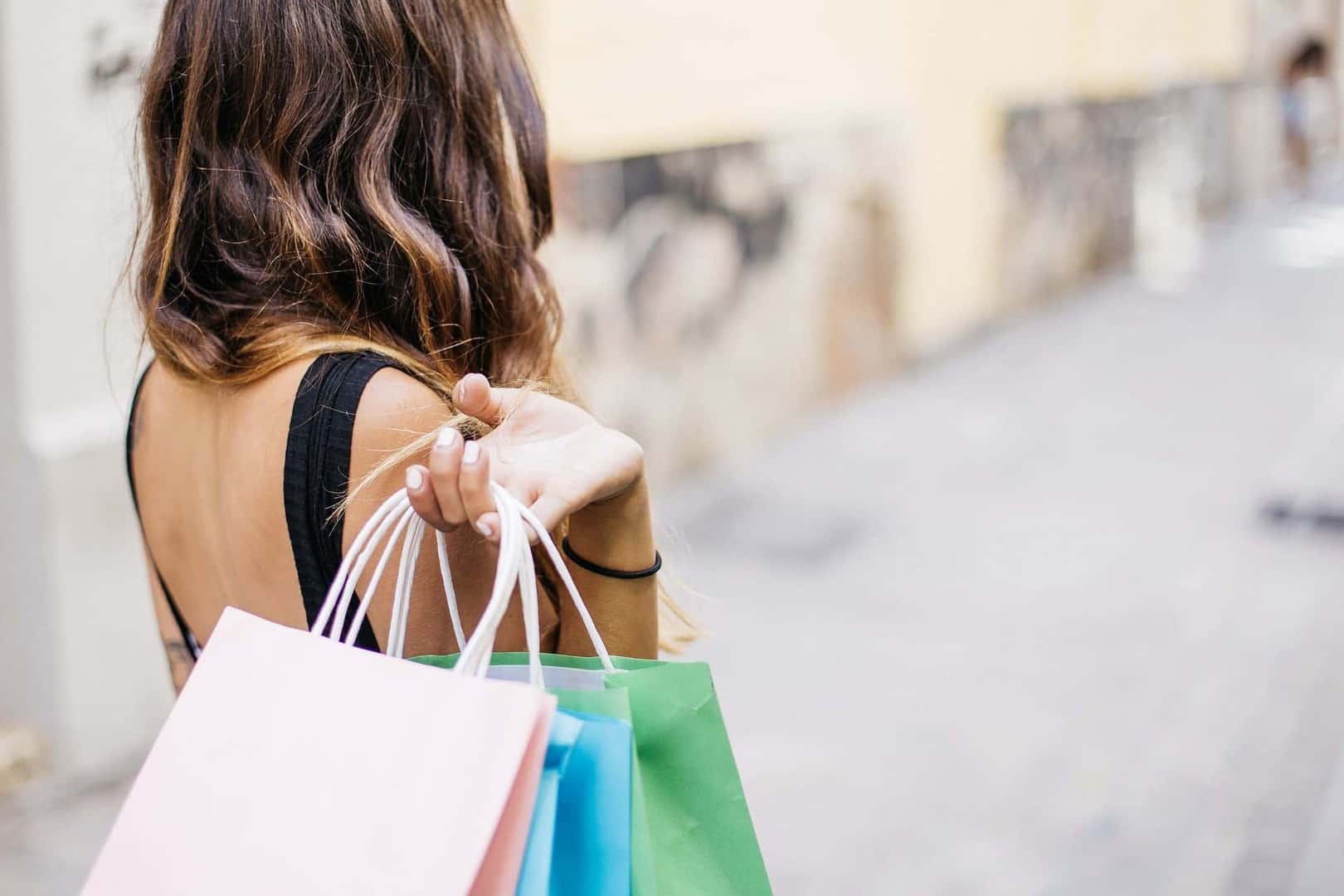 Woman holding shopping bags over her shoulder