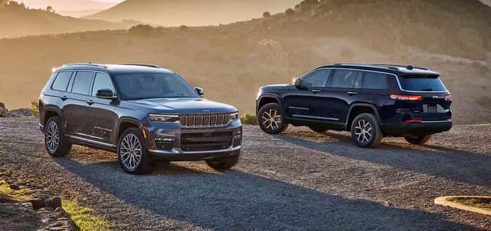 2 Jeep Grand Cherokees parked on rocks