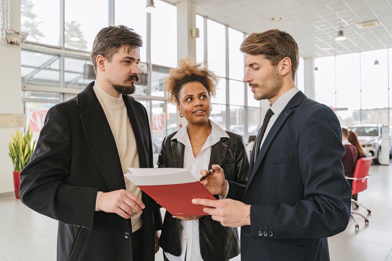 couple talking to ford dealer